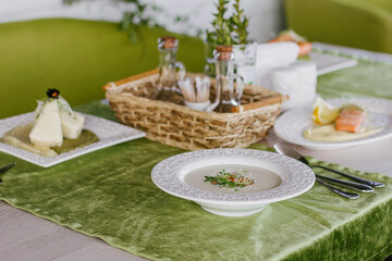 Cheese soup with salmon in green interior background