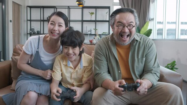 Son and dad playing video game at home