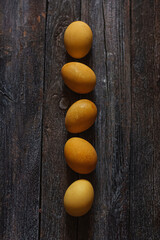 Natural dye for Easter eggs - turmeric on vintage wooden background