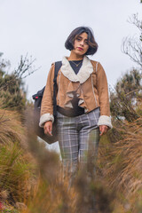 Young woman walking along a mountain path.