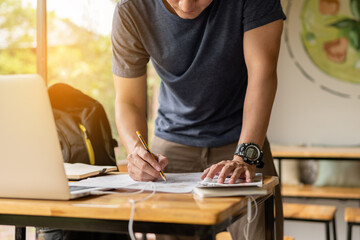 Traveler is planning vacation using the world map. Man is pointing on the map while the man is discussing.