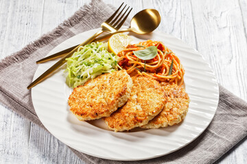cod fish patties with pasta and salad