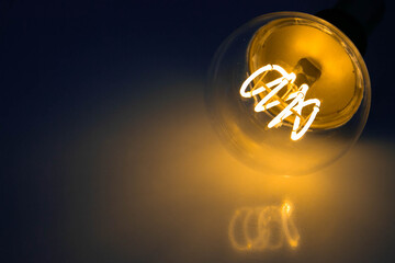 Orange Led shiny Bulb With Black Background and reflected light