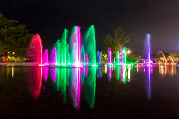 Beautiful multicolored fountain illuminated at night