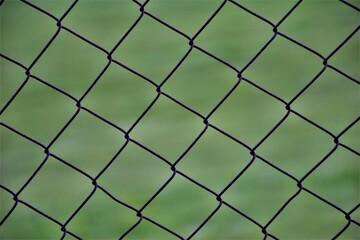 Fototapeta premium wire fence with green background