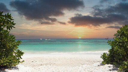 empty beach with clear water and blue sky in summer at sunset