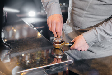 The barista prepares delicious coffee in a modern coffee shop close-up.