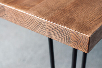 Wooden table. Corner of the table. Furniture element. Background.