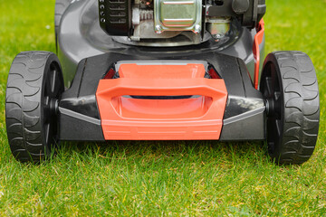 Lawn mower across a green lawn. Mow the lawn for a green lawn 