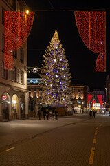 Fototapeta na wymiar Giant Christmas tree at the Kleber place in Strasbourg city at night during the year end celebration, Strasbourg, France