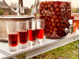 Cherry liqueur in shot glasses and bottle.