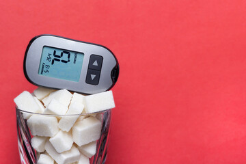 A device for measuring blood sugar on a glass with sugar cubes.