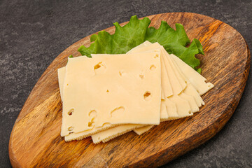 Sliced yellow cheese over board