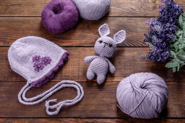 Toy hare tied from woolen threads on a dark background