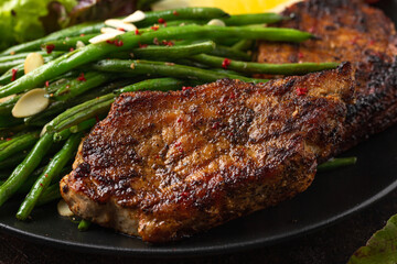 Grilled pork loin chops served with French green beans salad and beer