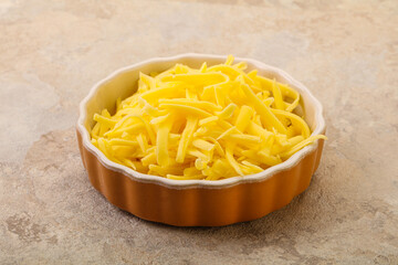 Shredded yellow cheese in the bowl