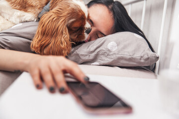 The dog wakes up the woman. The girl wakes up in the morning at home. Close-up photo