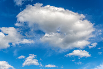 Naklejka na ściany i meble Blue sky with white beautiful clouds as an abstract background.
