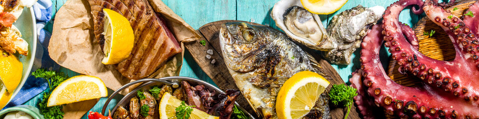 Assortment various barbecue Mediterranean grill food - fish, octopus, shrimp, crab, seafood, mussels, summer diet bbq party fest, with kebab, sauces, light blue sunny wooden background