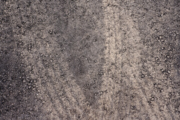 Traces of car tires on the new asphalt