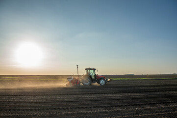 Naklejka premium Sowing crops at agricultural fields in spring