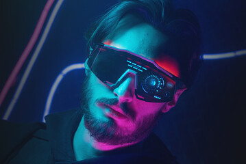 Serious man in the glasses in the neon lights close up portrait.