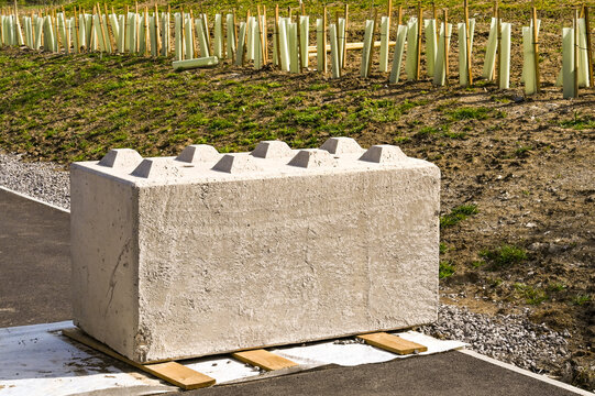 Large heavy concrete block placed on a path to block access to private land. No people.