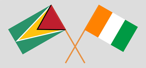 Crossed flags of Guyana and Republic of Ivory Coast. Official colors. Correct proportion