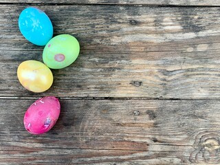 Multi-colored chicken eggs on a wooden background. Copy space. Festive postcard. Easter postcard.