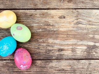 Multi-colored chicken eggs on a wooden background. Copy space. Festive postcard. Easter postcard.