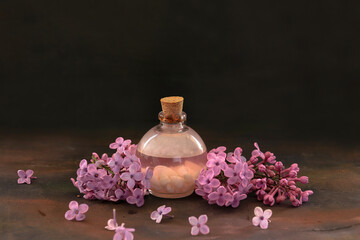 Obraz na płótnie Canvas Lilac flowers, lilac oil in bottle, spa