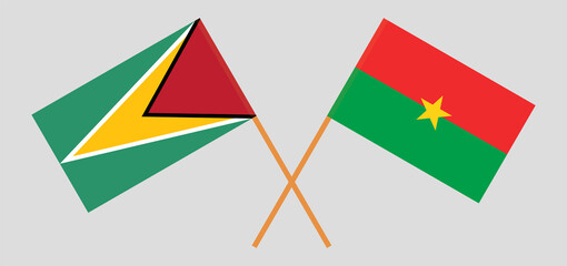 Crossed flags of Guyana and Burkina Faso. Official colors. Correct proportion