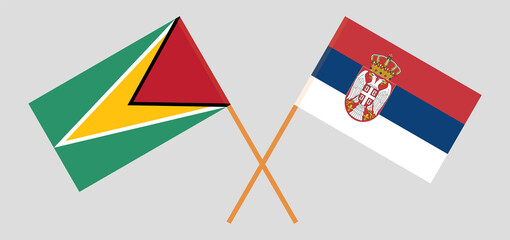Crossed flags of Guyana and Serbia. Official colors. Correct proportion