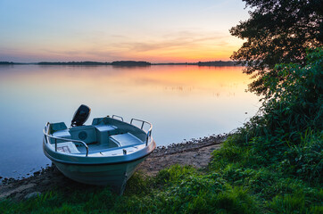 Masurian lake, sunset, motor boat