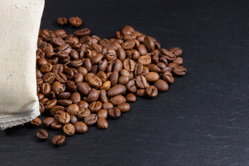 Scattered coffee beans from the bag, side view