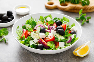 Fresh vegetable greek salad with lettuce, olives and feta cheese