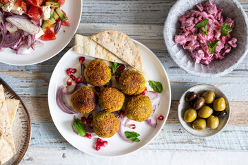 Middle eastern spread with falafel, olives and beetroot salad