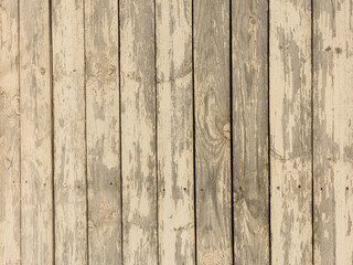 The surface is made of vertical old boards with peeling paint. Wooden texture