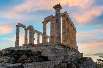 Fototapeta na wymiar Temple of Poseidon at Cape Sounion, Attica - Greece. One of the Twelve Olympian Gods in ancient Greek religion and myth. He was god of the sea, other waters and of earthquakes. Sunset with cloudy sky