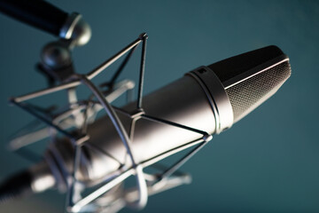 Professional studio microphone on blue background 