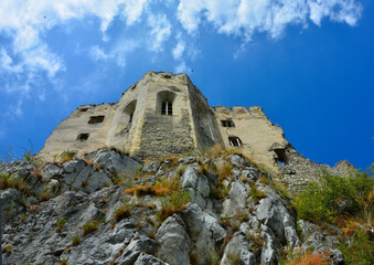 ruiny zamku na skale, ruins of a castle on a rock hills against blue sky, castle on a hill