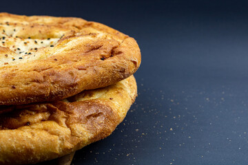 Traditional Turkish Ramadan Pita (Ramazan Pidesi) on black background. Traditional ramadan foods. Turkish bakery. Iftar background.