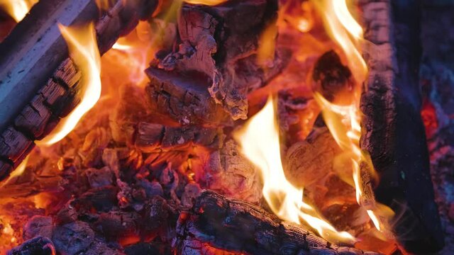 Close up picture of wood burning in a camp fire. Hot Red Flames. Taken in British Columbia, Canada. Slow Motion