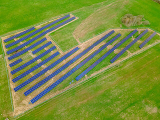 Photovoltaic panels installed on a green field outside the city, renewable energy farm