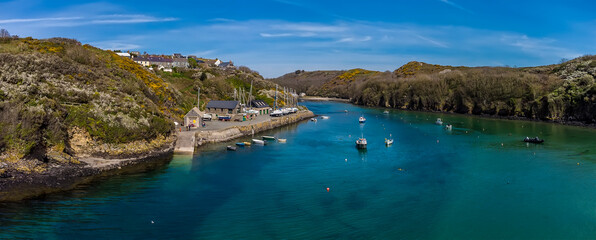 Obraz premium A panorama aerial view across the entrance to the inlet at Solva, Pembrokeshire, South Wales on a sunny day