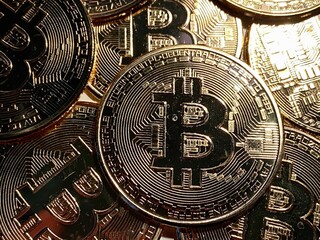 Golden bitcoin background, bitcoin is most popular crypto currency with copy space