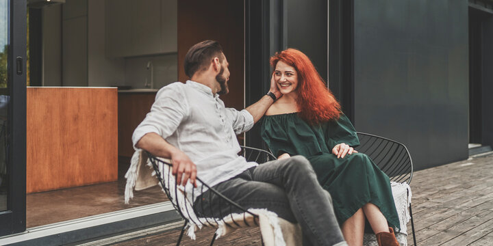 Side view of family couple spending time together at terrace - Powered by Adobe