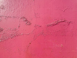 Red pinkish texture of a metallic iron old wall painted with cracks and abrasions. The background. Texture
