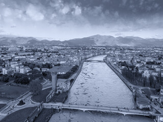 Aerial view of the Arno river during flood, Pisa, Italy