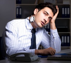 Tired and exhausted helpdesk operator during night shift